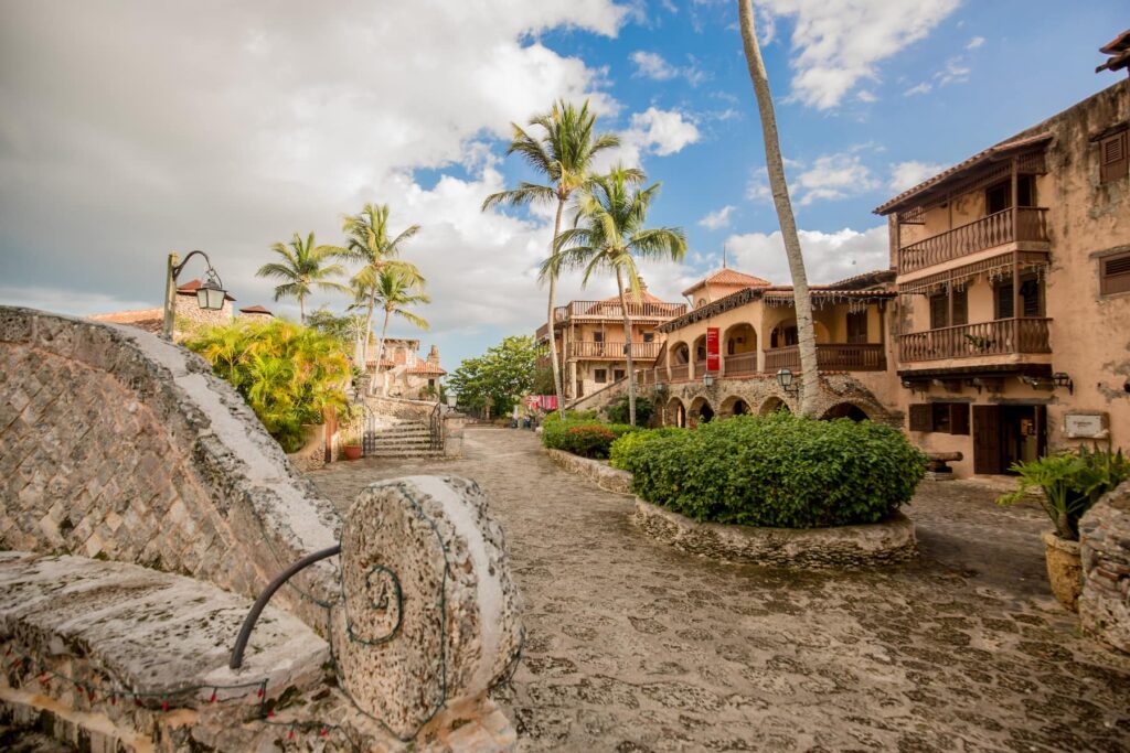 Sunset over Altos de Chavón, highlighting terracotta rooftops and lush Caribbean surroundings