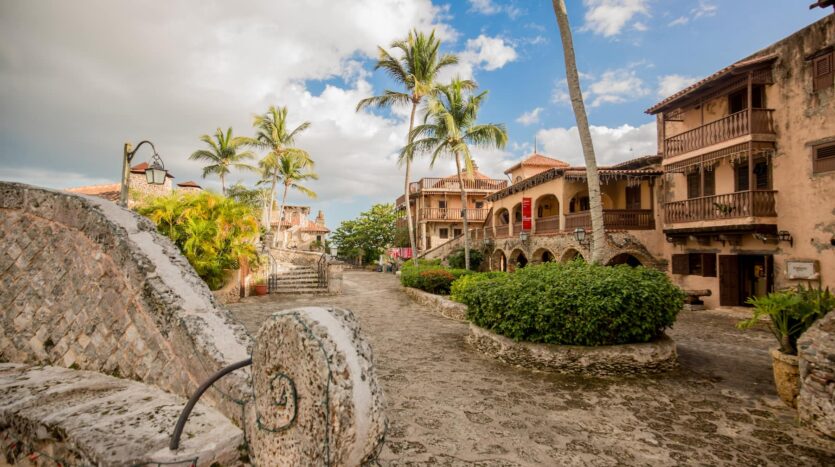 Sunset over Altos de Chavón, highlighting terracotta rooftops and lush Caribbean surroundings