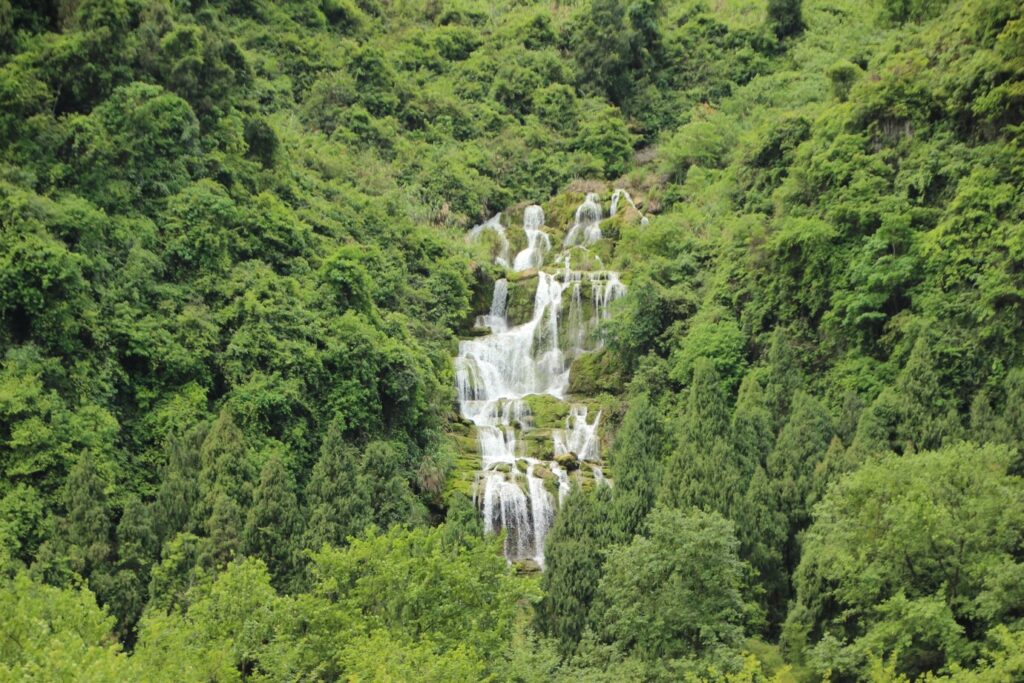 Tour group climbing rocks and exploring waterfalls at 27 Charcos de Damajagua in the Dominican Republic