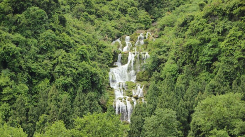 Tour group climbing rocks and exploring waterfalls at 27 Charcos de Damajagua in the Dominican Republic
