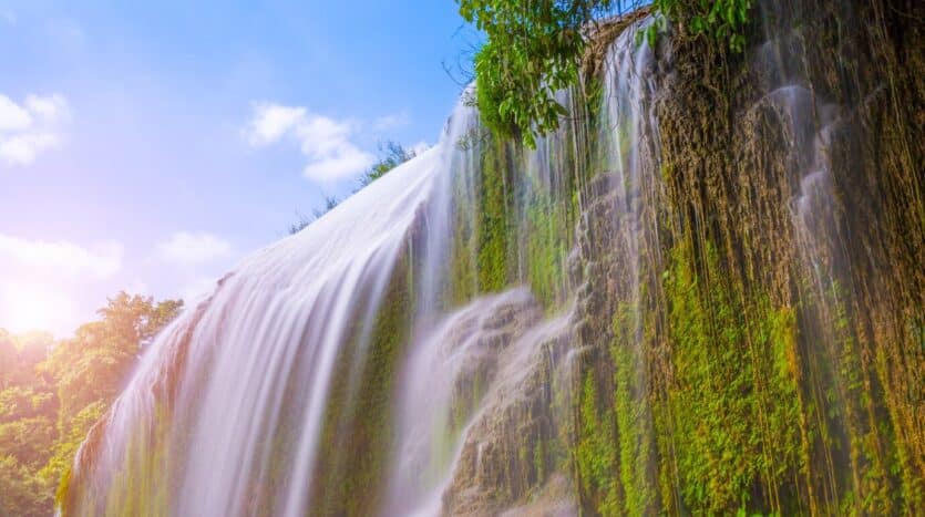 Adventurers jumping into a natural pool at the 27 Waterfalls of Damajagua in the Dominican Republic
