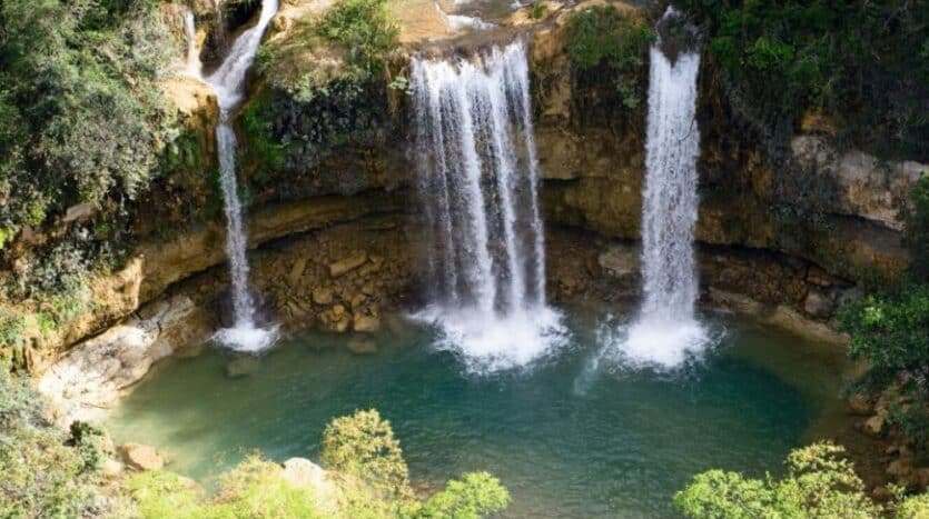 Visitors swimming in the natural pool at Salto De Socoa Waterfall, Dominican Republic.