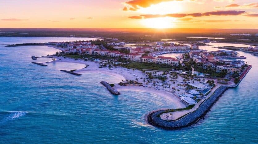 Couple enjoying a romantic sunset at Api Beach Cap Cana, Dominican Republic.