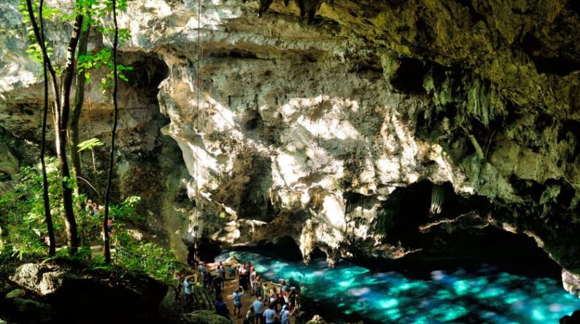 Sunlight streaming through the entrance of a large cave in the Dominican Republic