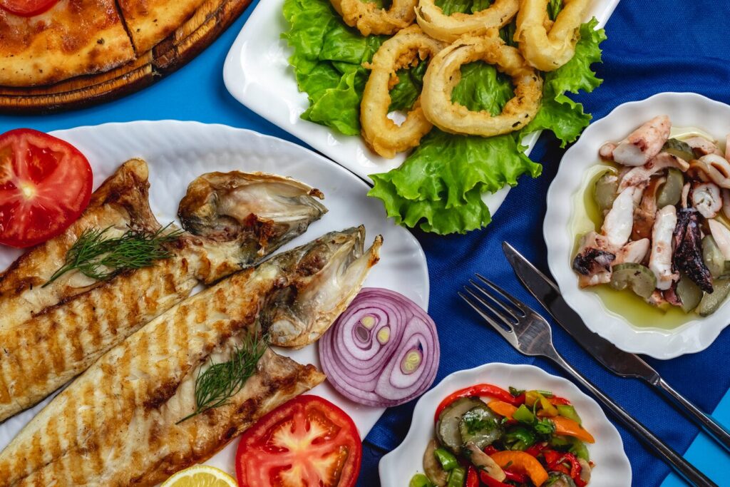 Local seafood market in the Dominican Republic with fresh fish, lobster, and shellfish on display.