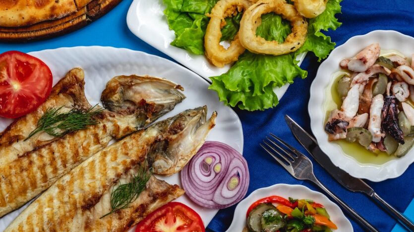 Local seafood market in the Dominican Republic with fresh fish, lobster, and shellfish on display.