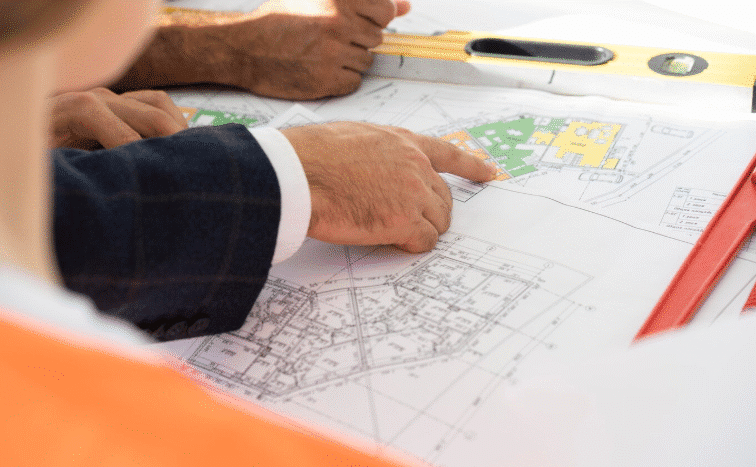 Official zoning map and land-use documents being reviewed for a building project in the Dominican Republic.