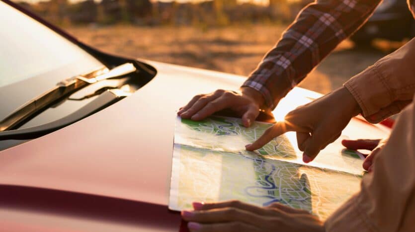 Car parked at a viewpoint overlooking Playa Rincón, one of the stops on the coastal route from Punta Cana to Samaná.