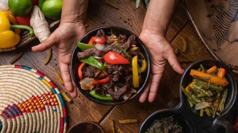 Trendy vegan café interior in Santo Domingo with minimalist décor and plant-based dishes on display.