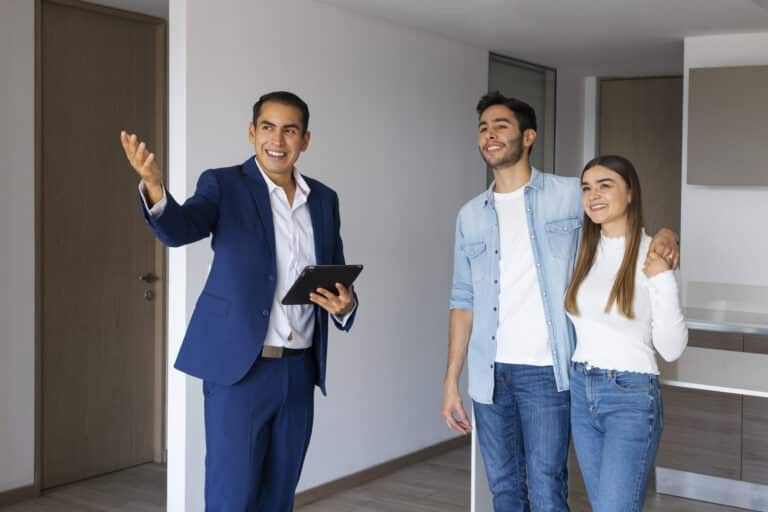 Real estate consultant in a Toronto office presenting Dominican Republic property options to clients.