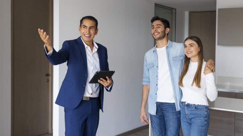 Real estate consultant in a Toronto office presenting Dominican Republic property options to clients.