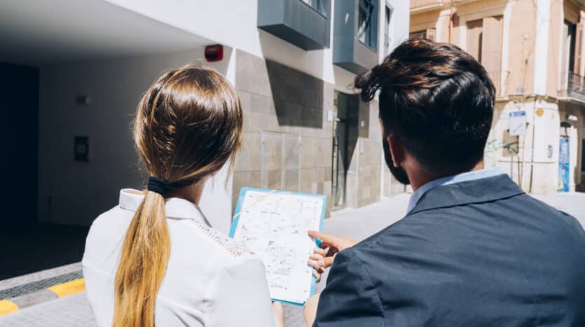 Architect reviewing blueprints with local officials during a building permit application process in the Dominican Republic.