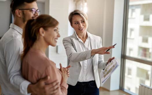 Real estate agent showing property listings in a modern office in Santiago, Dominican Republic.