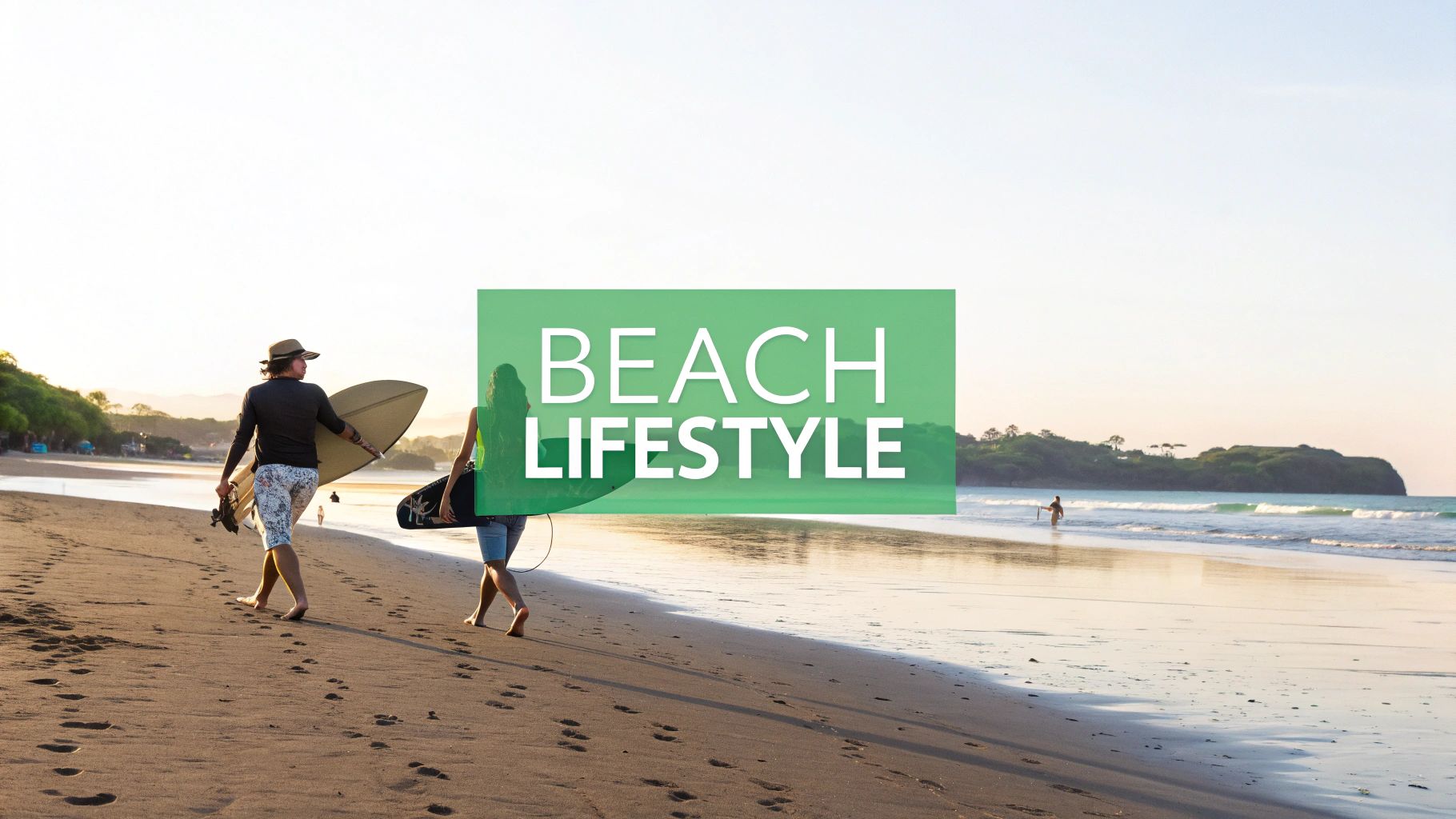 Two people, a man and a woman, walk on a sandy beach carrying surfboards at sunset.